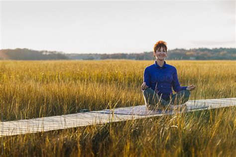 Zen Red Head Senior Woman Bending Over In Yoga Pose By Stocksy