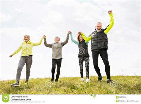 Group Of Senior Runners Outdoors Resting Holding Hands Stock Image