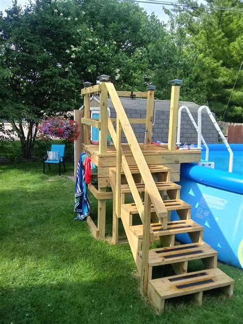 An Above Ground Swimming Pool With Steps Leading Up To The Upper Deck