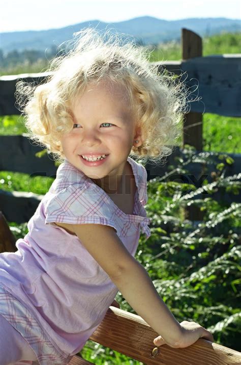 Outdoor Shoot Of Little Funny Blonde Curly Girl Stock Image Colourbox