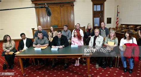 Members Of The Jury Sit Together As They Read A Statement During A