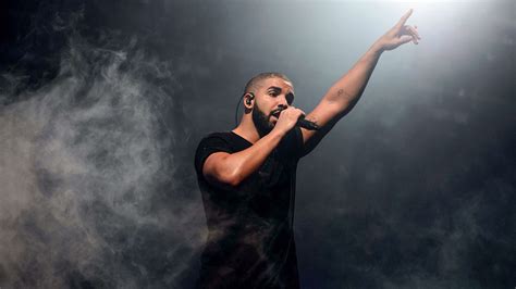 Drake In Black Fog Background Having Mike In Hand Wearing Black T Shirt