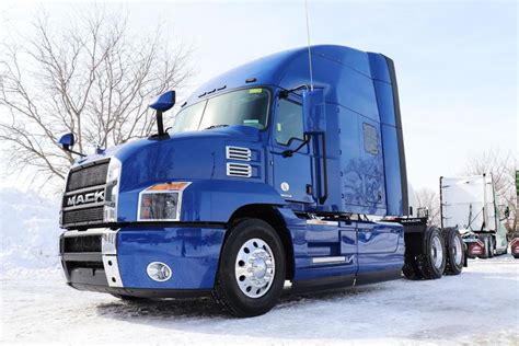 A Blue Semi Truck Parked In The Snow