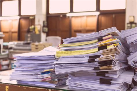 Pile Of Documents On Desk Stack Up High Waiting To Be Managed Global