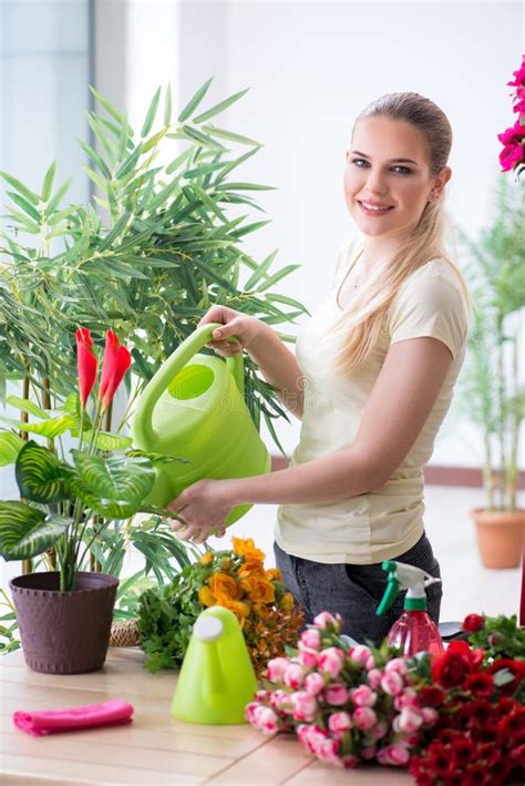The Young Woman Watering Plants In Her Garden Stock Photo Image Of
