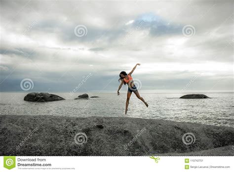 Woman Jumping On A Rock At Sunset On Bakovern Beach Cape Town Stock Image Image Of Shorts