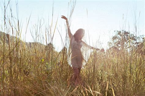 Young Sensual Woman Dancing In High Grass Field By Visualspectrum