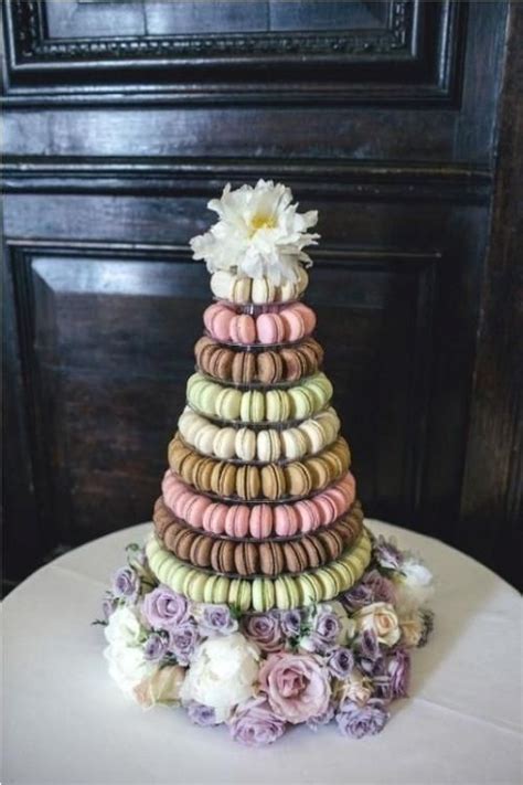 A Wedding Cake Made Out Of Macaroons And Flowers