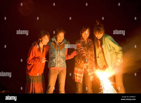 Four Young Women Playing With Sparklers Stock Photo Alamy
