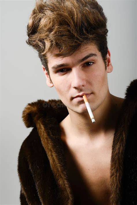Attractive Young Man Wearing Fur Coat With Modern Hairstyle Stock