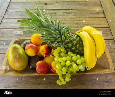 Wooden Bowl Full Of Fruit Bananas Pineapple Grapes Mango