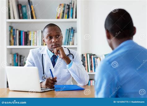 African American Doctor With Male Patient Stock Image Image Of Attack