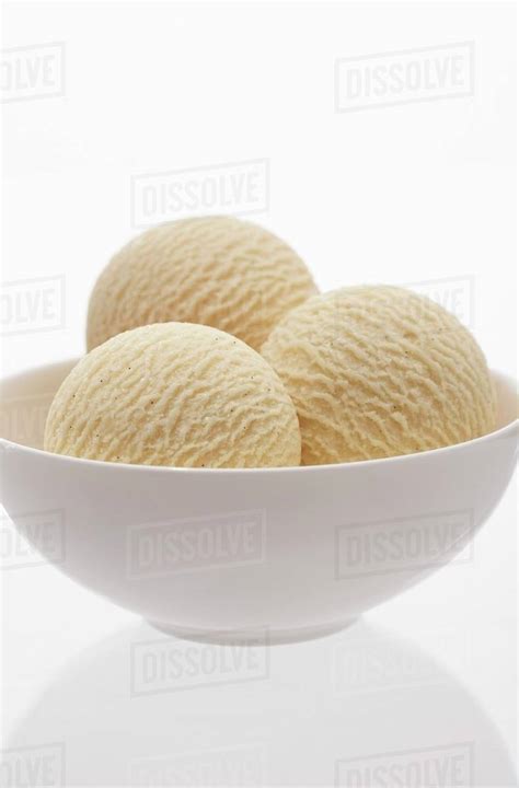 Three Scoops Of Vanilla Ice Cream In A Bowl Stock Photo Dissolve