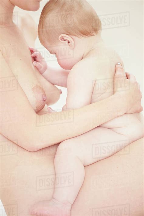 Naked Mother Bonding With Naked Baby On Lap Stock Photo Dissolve