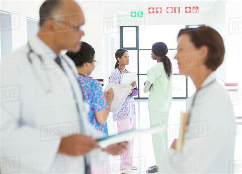 Doctors And Nurses Talking In Hospital Corridor Stock Photo Dissolve