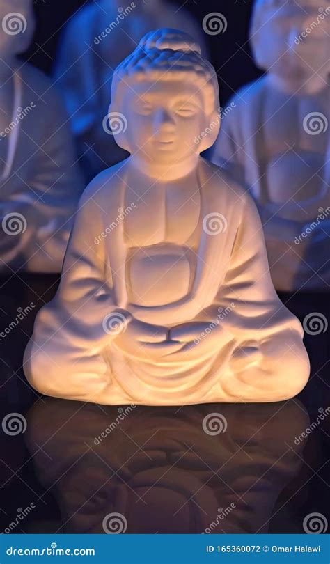 Buddha Statue With Candles For A Moment Of Relaxation Stock Photo