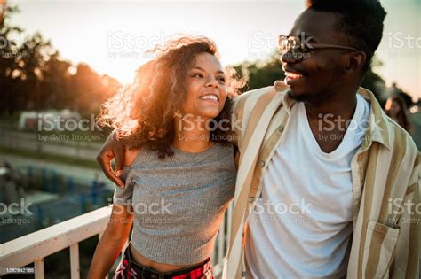 Happy Black Couple Enjoying In Their Walk At Sunset Stock Photo
