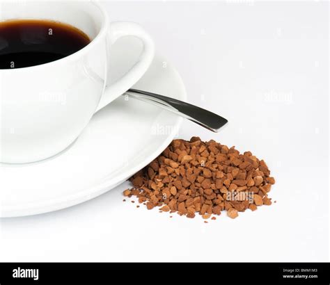 A Cup Of Black Coffee With A Pile Of Instant Granules To The Side Stock