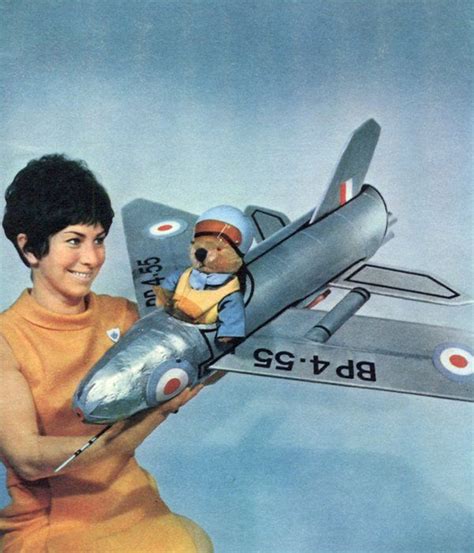 A Woman Holding A Toy Airplane With A Teddy Bear In It S Pilot S Seat