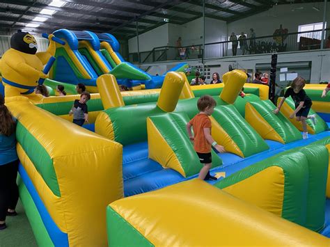 Bounce Into Inflatable World Charmhaven Playing In Puddles