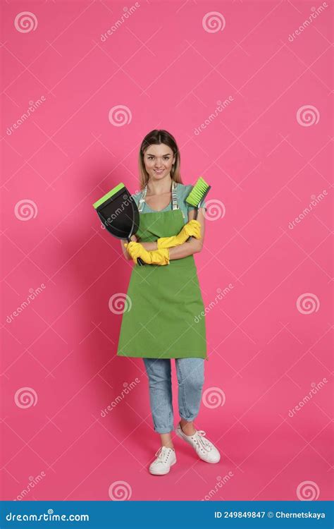 Young Woman With Broom And Dustpan On Pink Background Stock Image