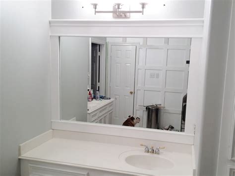 Bathroom features a salvaged wood trim doorway, a white oval freestanding bathtub, faux bois accent table, gray mosaic accent tiles, and a gold french mirror flanked by camille long sconces and. Engineering Life and Style: Framing Contractor Grade Mirrors