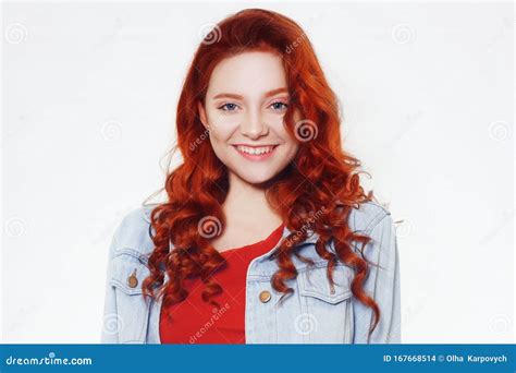 Portrait Of Beautiful Cheerful Redhead Girl With Flying Curly Hair Smiling Laughing Looking At