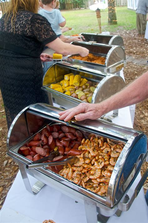 People Are Serving Themselves Food At An Outdoor Event