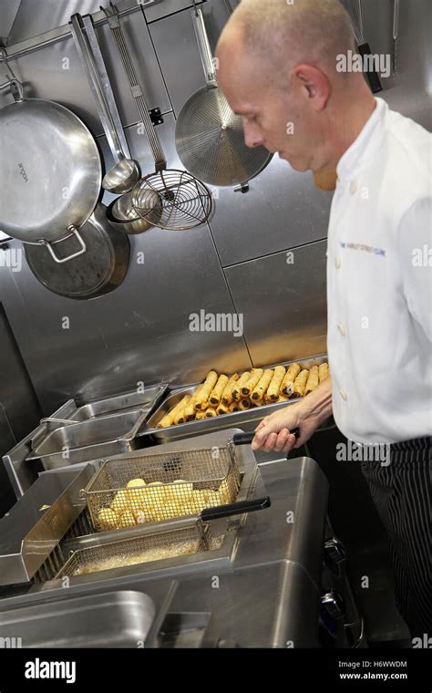 Chef Deep Frying Food In A Commercial Kitchen In The Uk Stock Photo Alamy