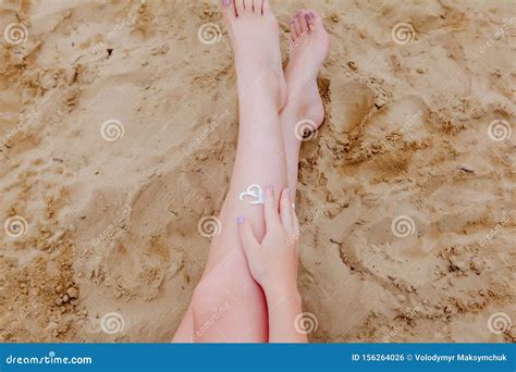 Girl Oil Spray Tanning Her Legs Protection From The Sun`s Uv Rays Putting Sunscreen Lotion