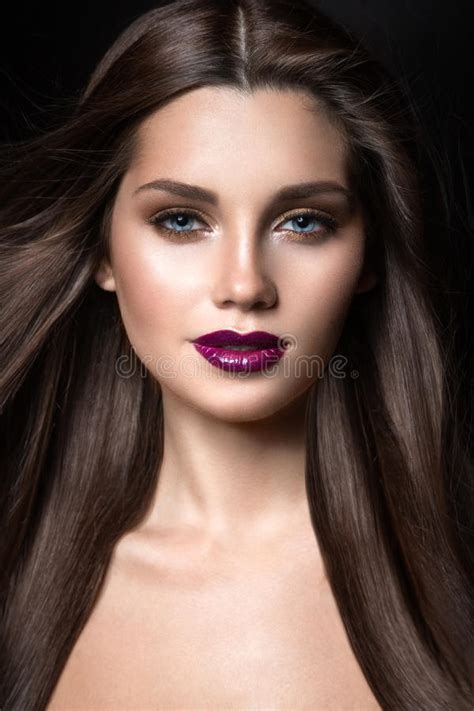 Beautiful Girl With Golden Makeup And Burgundy Lips With