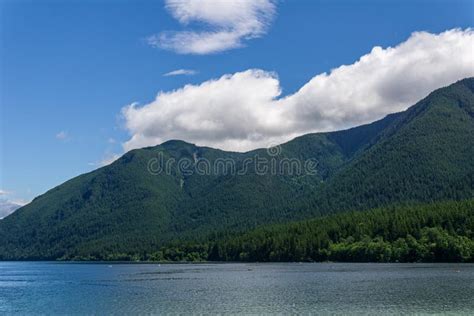 Blue Mountain Lake With Green Mountains Blue Sky And White Clouds Stock