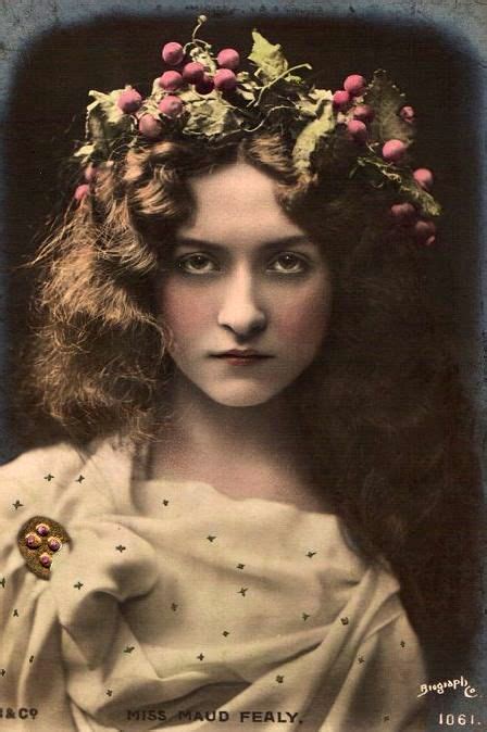 An Old Black And White Photo Of A Woman With Long Hair Wearing A Flower