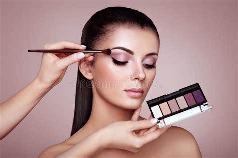 Makeup Artist Applying Make Up On Beautiful Model Stock Photo Image