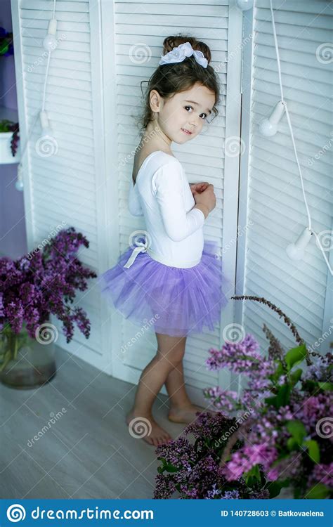 Adorable Little Girl Dressed As A Ballerina In A Tutu Tying Her Ballet
