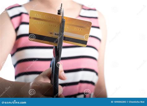 Portrait Of Young Woman Cutting Up A Credit Card With Scissors To Stop