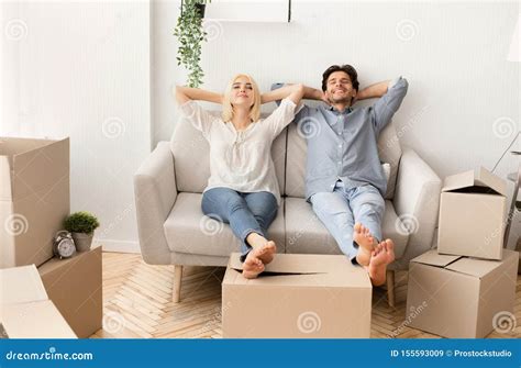 Joyful Husband And Wife Relaxing On Couch In New Home Stock Image Image Of Gladful Cardboard