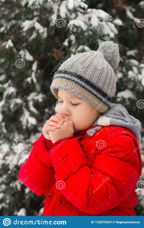 Winter Cold The Boy Blows On His Hands Warming Them Stock Photo