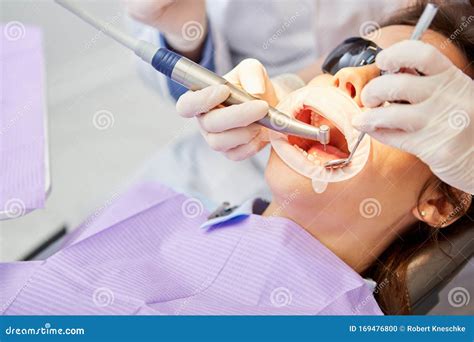Dentist With Drill During Treatment Stock Photo Image Of Assistant
