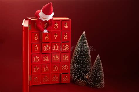 Christmas Advent Calendar With An Elf And Ts On Red Background Stock