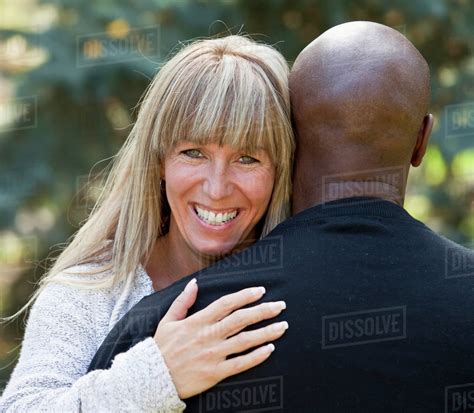 Interracial Married Couple Hugging In A Park Edmonton Alberta Canada