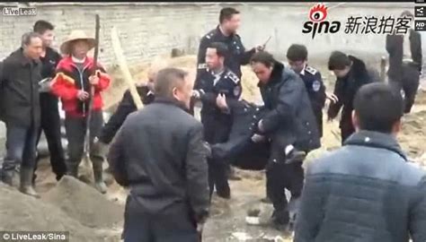 horrifying moment chinese police officer is killed after being struck on the head from behind
