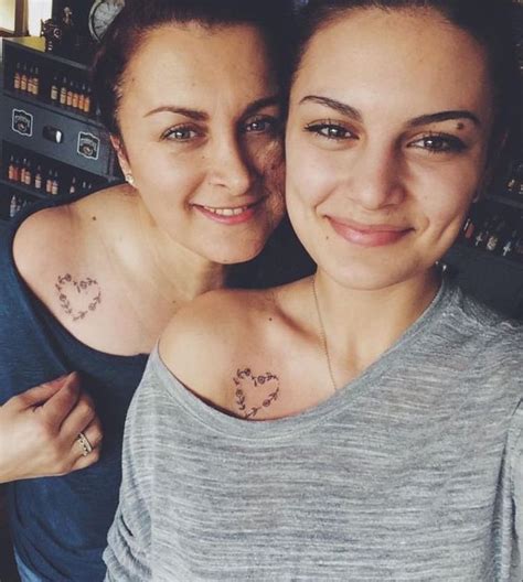 mother and daughter matching tattoos floral hearts shoulder tattoos grey and blue blouses