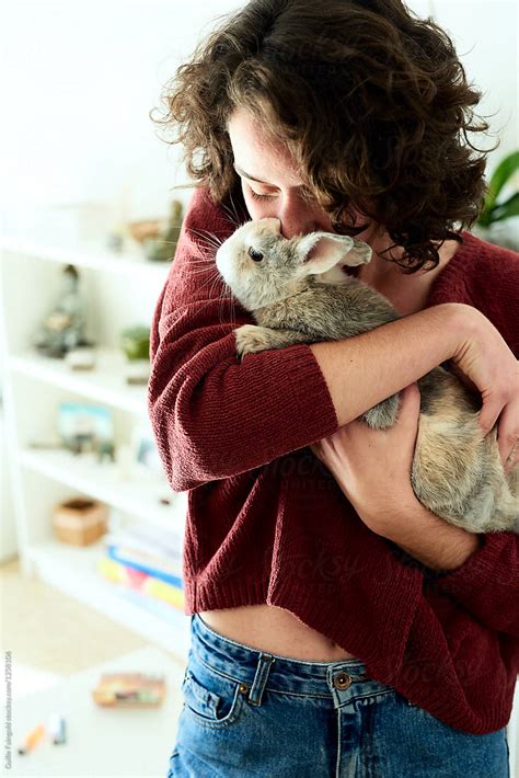Woman Kissing Domestic Rabbit By Stocksy Contributor Guille Faingold