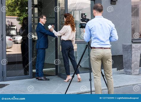 Professional Cameraman And Journalist With Businessman Stock Image