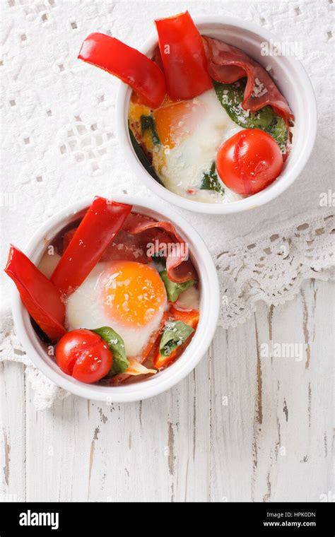 Baked Egg With Spinach Peppers Tomatoes And Cheese In A Cup Close Up