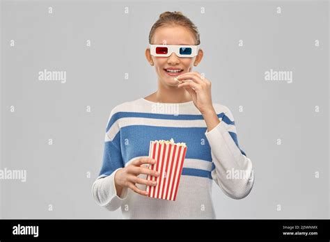 Teenage Girl In 3d Movie Glasses Eating Popcorn Stock Photo Alamy