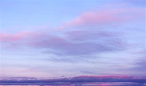 Blue Sky Background With Purple And Pink Clouds Stock