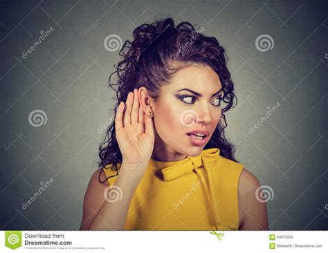 Curious Woman With Hand To Ear Secretly Listening To Gossip Stock Photo