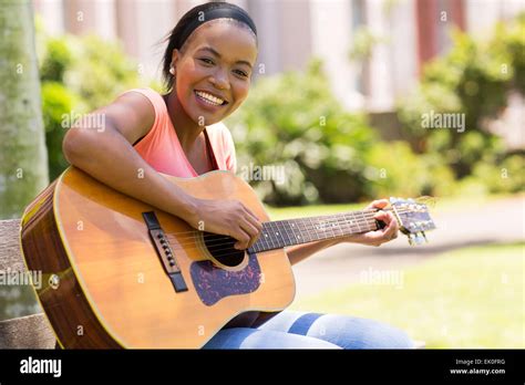 Beautiful African American Woman Playing Guitar Outdoors Stock Photo